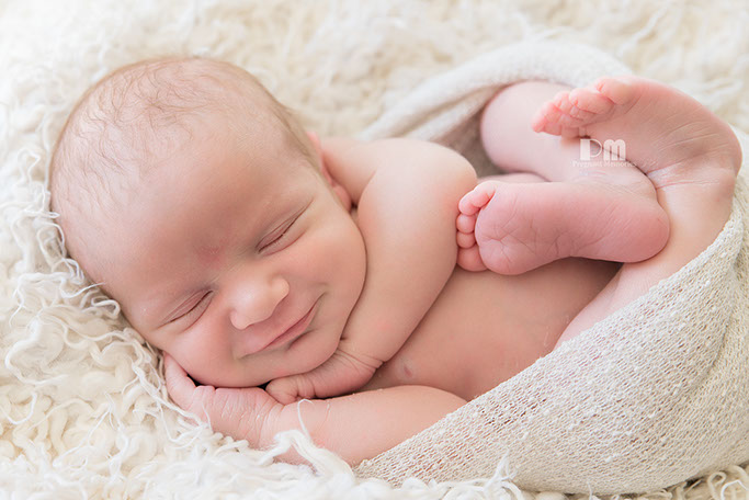 Gold Coast Photoshoot of smiling newborn.